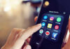 Injury Excuse, Internet Outrage Collide Finger tapping smartphone social media app icons.