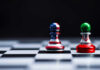 Chess pieces with USA and Iran flags on board.