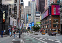 Mayor’s Freeze — Prices Spike Anyway? Times Square street scene with storefronts and advertisements.
