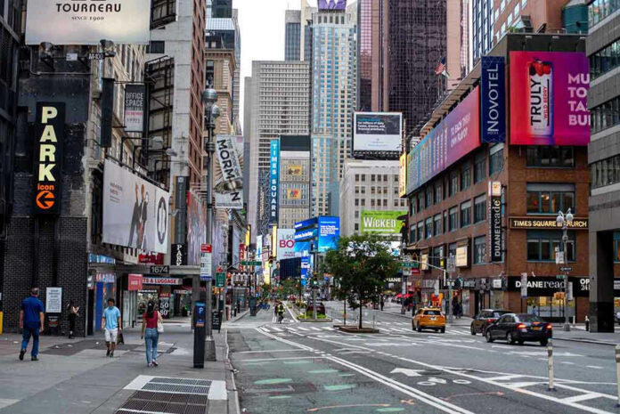 1927789745 Times Square street scene with storefronts and advertisements.