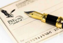 Border Crackdown Gets Blank Check Close-up of a check with a fountain pen and an eagle illustration
