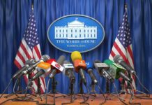 Press microphones at a White House briefing podium
