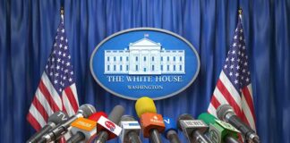 Press microphones at a White House briefing podium