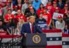 speaker at podium addressing crowd at rally