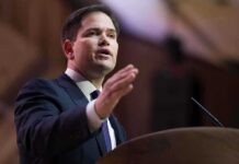 Rubio’s Terror Play Sparks Diplomatic Firestorm A man in a suit delivering a speech at a podium
