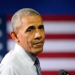 Viral Edit Warps Obama’s Voting Answer man speaking at podium with american flag backdrop