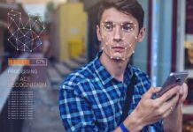 Celebs Tagged and Fans Tracked at Madison Square Garden Young man using a smartphone with face recognition overlay