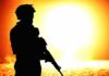 Abrupt Army Purge — Lieutenant General Removed silhouette of an armed soldier against a bright fiery background