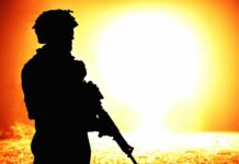Abrupt Army Purge — Lieutenant General Removed silhouette of an armed soldier against a bright fiery background