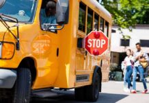 School Bus Standoff Sparks Arrest School bus with extended stop sign near students on sidewalk