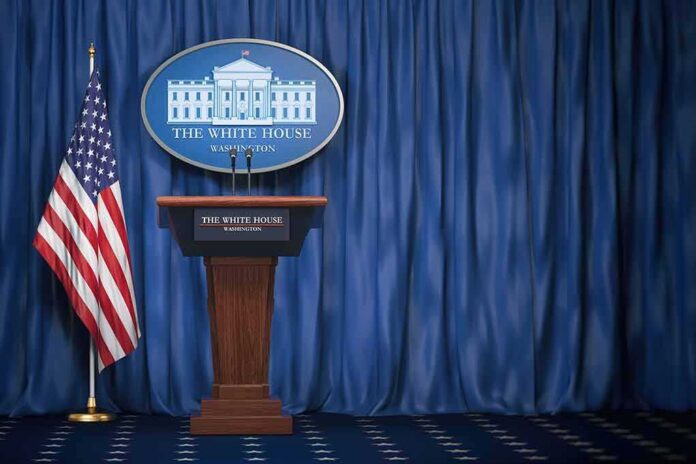 White House press briefing podium with U.S. flag and blue curtain