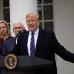 Talks Back On? War Games Dialed Down man speaking at podium with officials standing behind