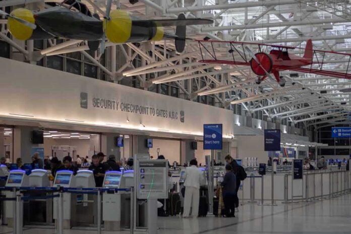 airport security checkpoint with passengers and hanging vintage airplanes