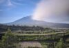 Evacuations Begin As Lava Roars Terraced farmland below a cloud-covered mountain