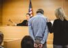Cover-Up Bombshell Shakes Mexico Defendant in handcuffs stands before a judge in a courtroom