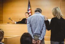 Cover-Up Bombshell Shakes Mexico Defendant in handcuffs stands before a judge in a courtroom