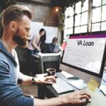 Veterans vs. Dragon — Why It Went Nuclear Man working at a computer with a loan form on screen