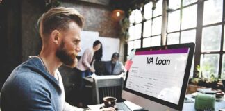 Man working at a computer with a loan form on screen
