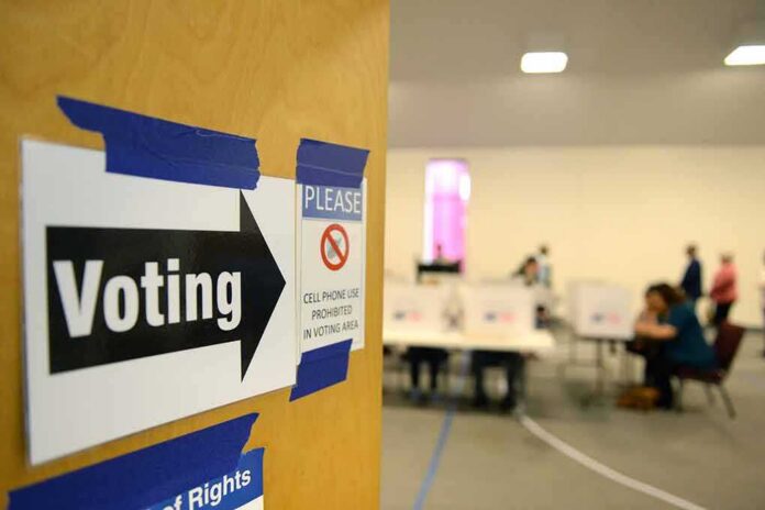 shutterstock_512226394 Voting sign on door leading to polling place