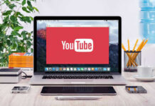 Political Rules Snag Elon Documentary YouTube logo on a laptop screen on desk.