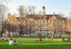 Foreign Cash Shadows Top Campuses Students relaxing on a campus quad in front of a brick academic building