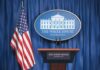 Hormuz Hostage Play – Trump Says No White House press briefing podium and US flag