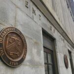 Trump Tax Windfall Stuns Treasury U.S. Treasury building exterior with bronze seal on stone wall