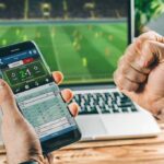 Betting Edge Exposed—AI’s World Cup Test Person checking live soccer betting odds on a smartphone