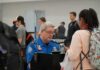 Bill Bergey, a TSA officer, checks a traveler's documents at an airport security checkpoint