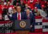 Hollywood Shock: Chris Rock Backs Trump two men at a podium during a large indoor rally