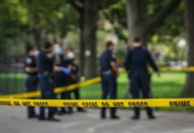 Rat Urine Warning – Camp Wiped Out crime scene tape with police officers in a park