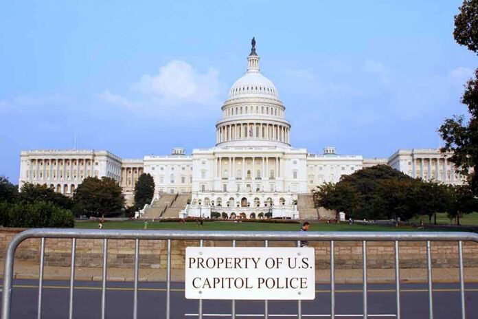 shutterstock_1913280 View of the U.S. Capitol building with a security barrier in front