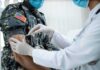 War Stress Exposes Hidden Hormone Crash Healthcare worker giving vaccine to person in military uniform