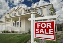 Dictator’s Heir Found In Ohio A suburban house with a For Sale sign in the front yard