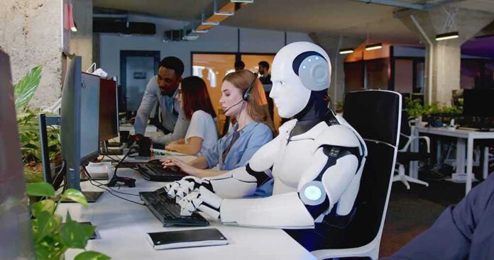 shutterstock_2229125163 Robot and office workers at computers in a modern workspace