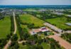 $10,000 Checks Rejected – What’s The Catch? Aerial view of rural landscape with roads, fields, and scattered buildings