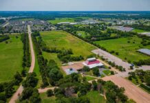 Aerial view of rural landscape with roads, fields, and scattered buildings