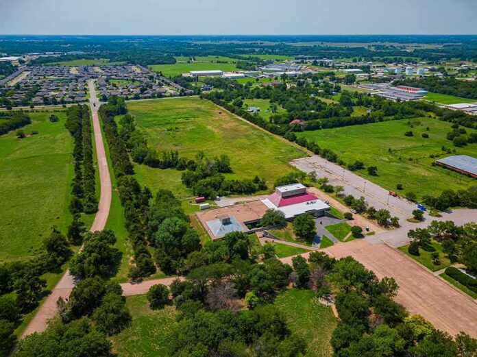Aerial view of rural landscape with roads, fields, and scattered buildings