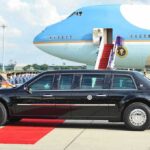 Xi Lands, Leverage Game Begins Presidential limousine beside a large blue-and-white jet on a runway
