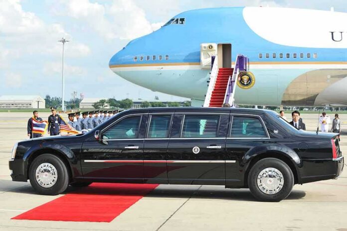shutterstock_315613541 Presidential limousine beside a large blue-and-white jet on a runway
