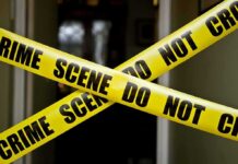 Crime Plunge Stuns America Yellow crime scene tape crossing a doorway