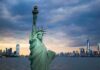 Inferno Near ‘Godfather’ Church Statue of Liberty with city skyline at dusk