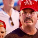 Man in red cap at a crowded event