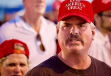 Man in red cap at a crowded event