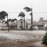 Houses battered by hurricane winds and flooding