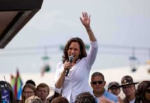 Kamala Harris Rally Sparks Mississippi Uproar Kamala Harris speaking at outdoor rally, Paul Scholes in the crowd