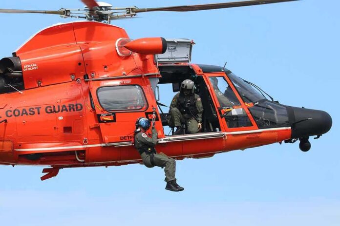 shutterstock_1496219480 Rescue helicopter with crew performing hoist operation