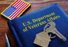 Smart Glasses For Vets – Strings Attached? VA folder with house keychain and US flag patch on wooden desk