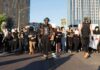 Armored Vehicles Roll Into Orléans Protesters march on a city street holding signs