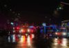 School Riots Turn Brutal Overnight Nighttime police scene with flashing lights on a wet city street